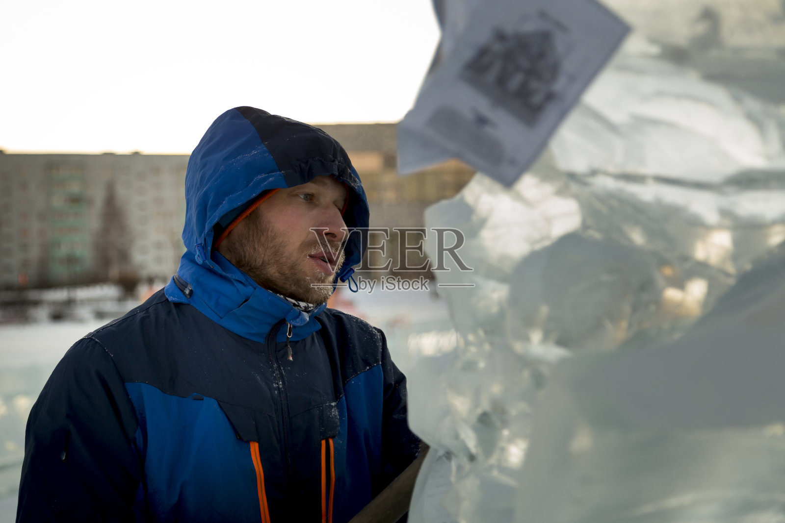 一名建筑工人的肖像，穿着蓝色的针织帽和蓝色的冬季夹克照片摄影图片