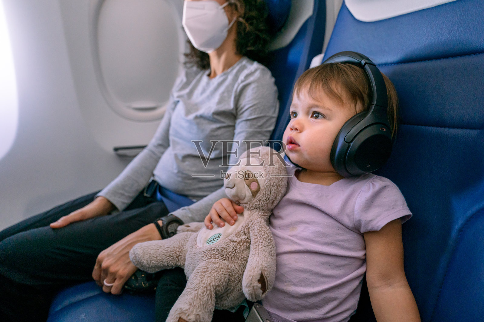 可爱的小女孩在飞机上看电影照片摄影图片