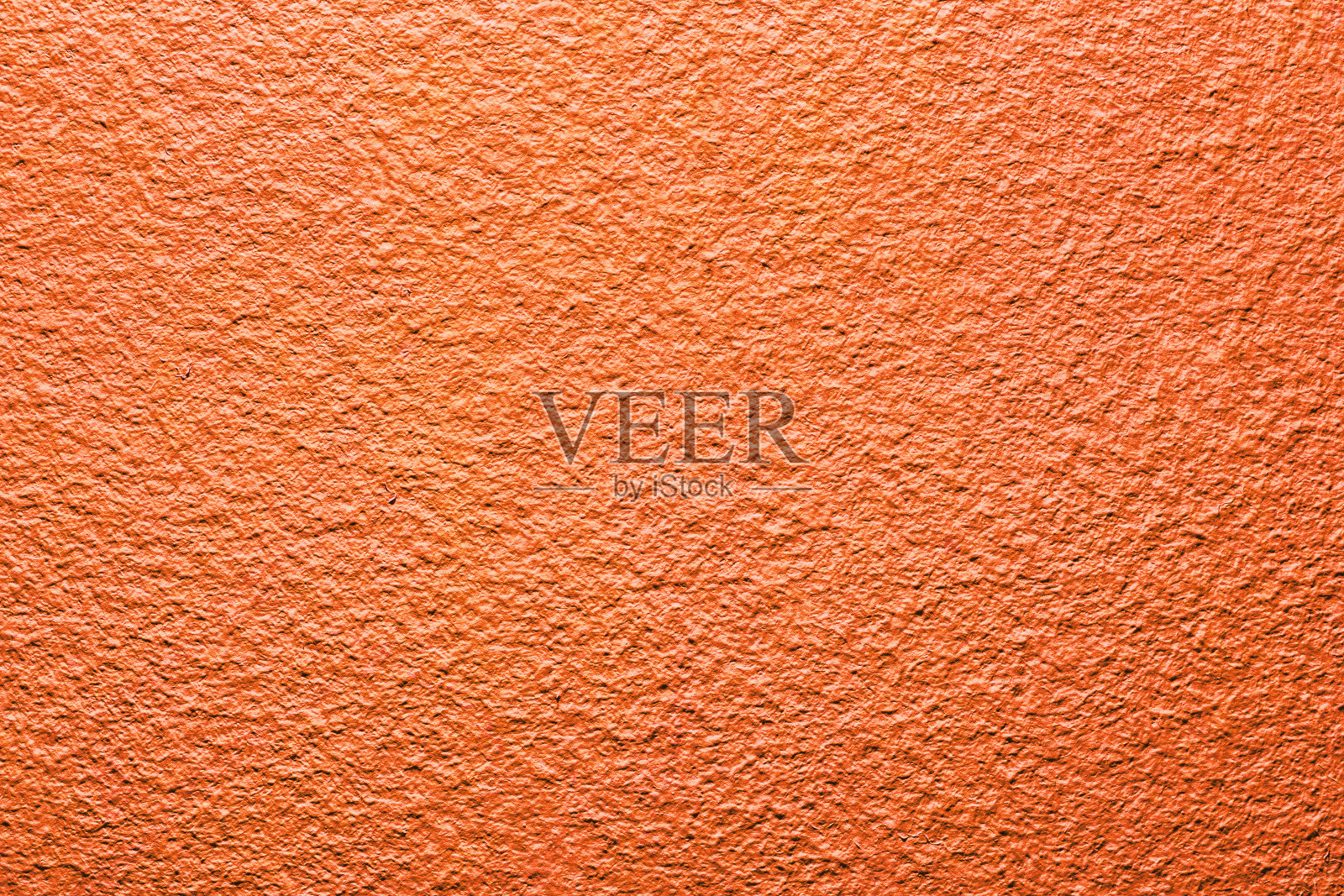 红橙墙背景。色彩鲜明的水泥纹理。石膏墙模式。照片摄影图片