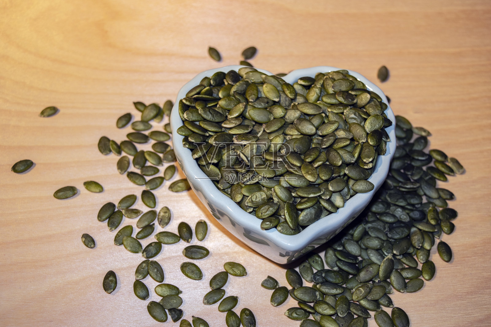 心形碗里的绿色南瓜籽(仁)照片摄影图片