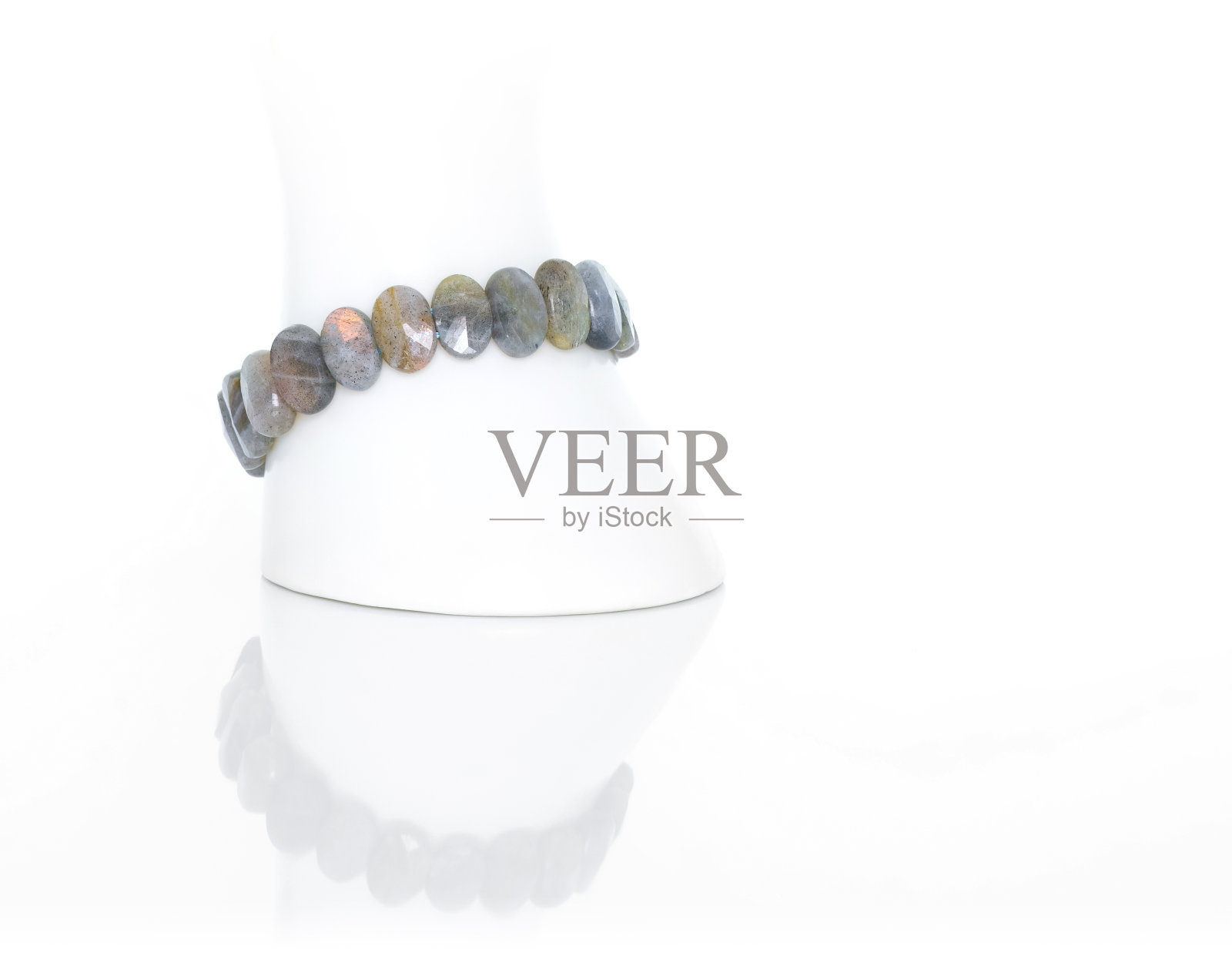 白色展示架上的拉布拉多石手镯。收藏天然宝石饰品。影棚拍摄照片摄影图片