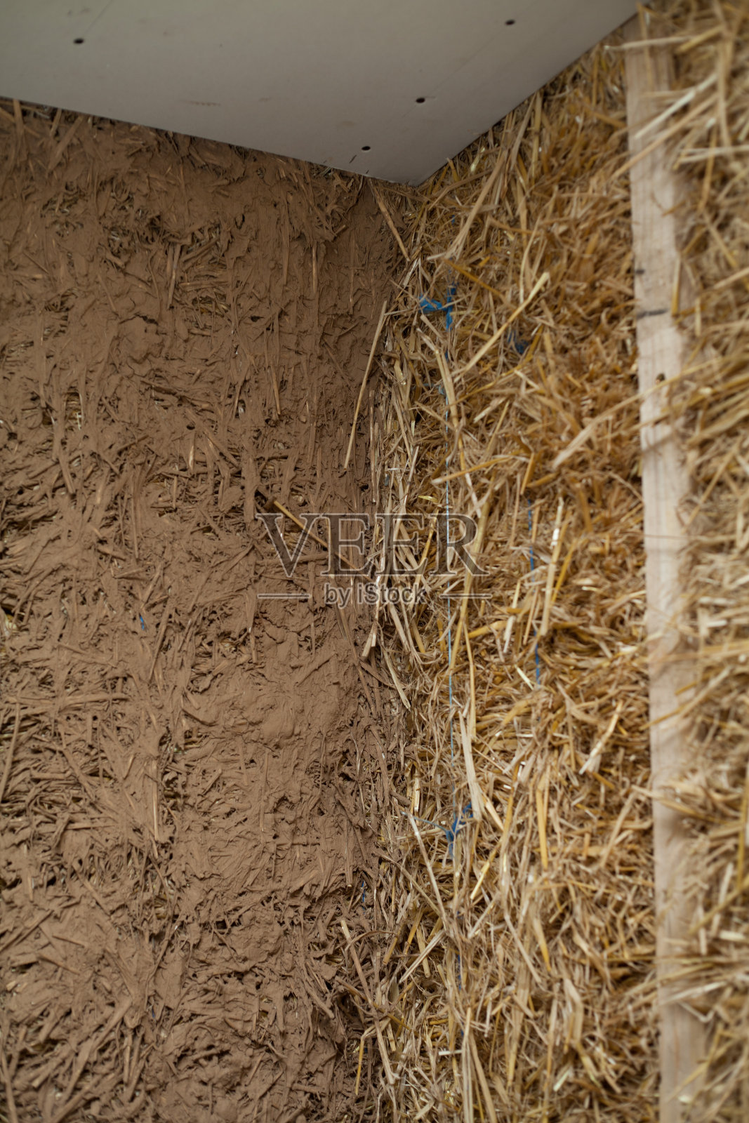 用草泥建造房屋-在建筑工地搅拌原料。传统建筑的古老技术。照片摄影图片