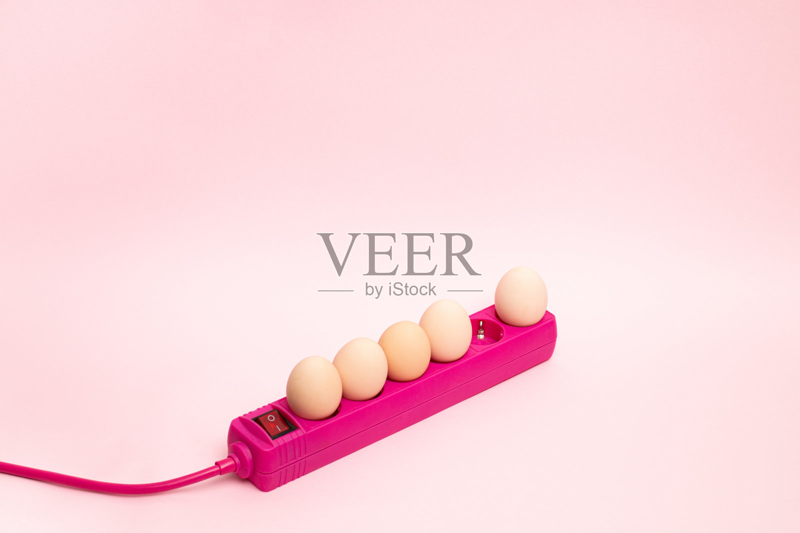 创意复活节概念与彩蛋插头与扩展粉红色电缆。最小的复活节想法。照片摄影图片