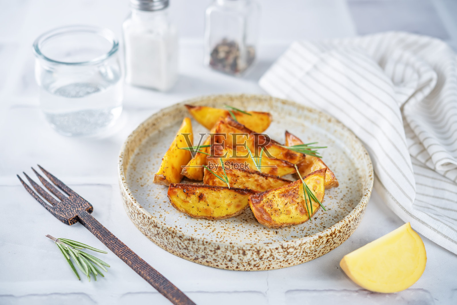 烤迷迭香土豆在盘子里照片摄影图片