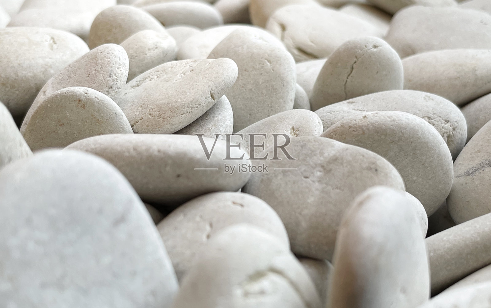 白色砂石的自然纹理。矿物表面的粗糙图案。照片摄影图片