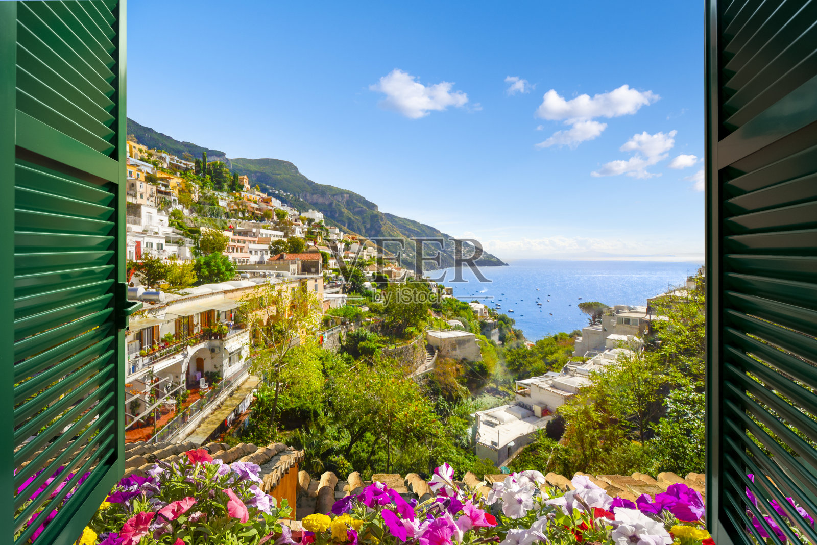 夏季，意大利南部阿马尔菲海岸的波西塔诺市(Positano)，透过百叶窗敞开的窗户，可以欣赏到山景、城市和海景。照片摄影图片