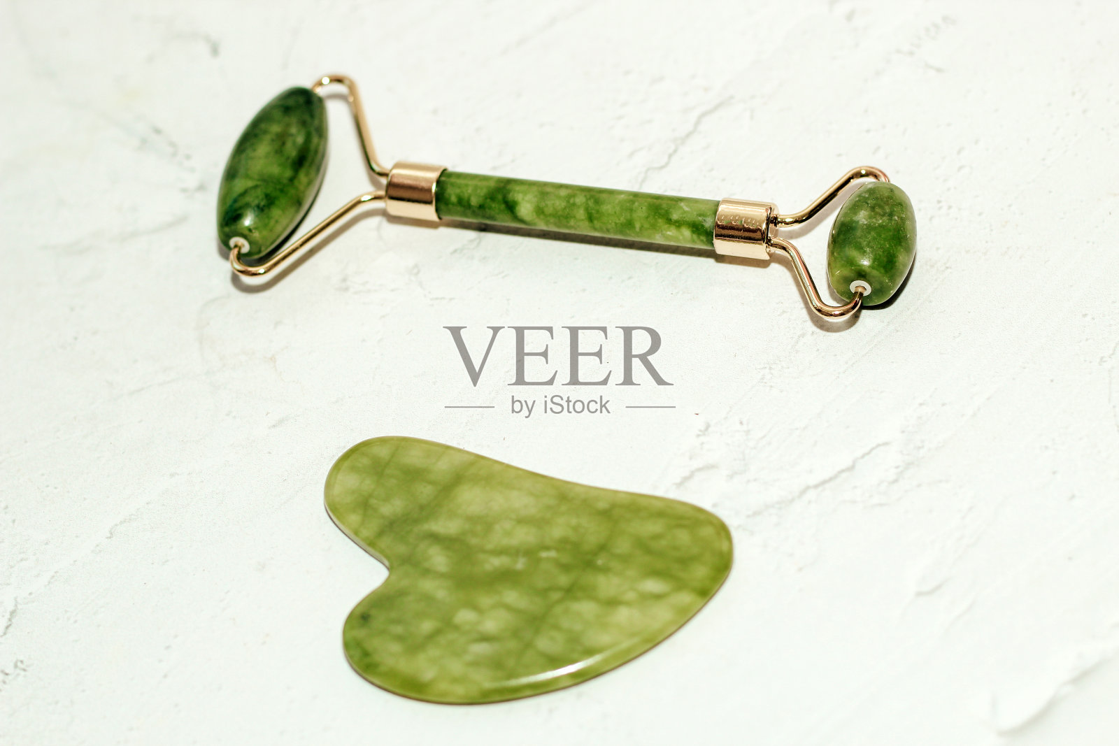 按摩石玉石水粉刮刀和面滚筒光背景照片摄影图片