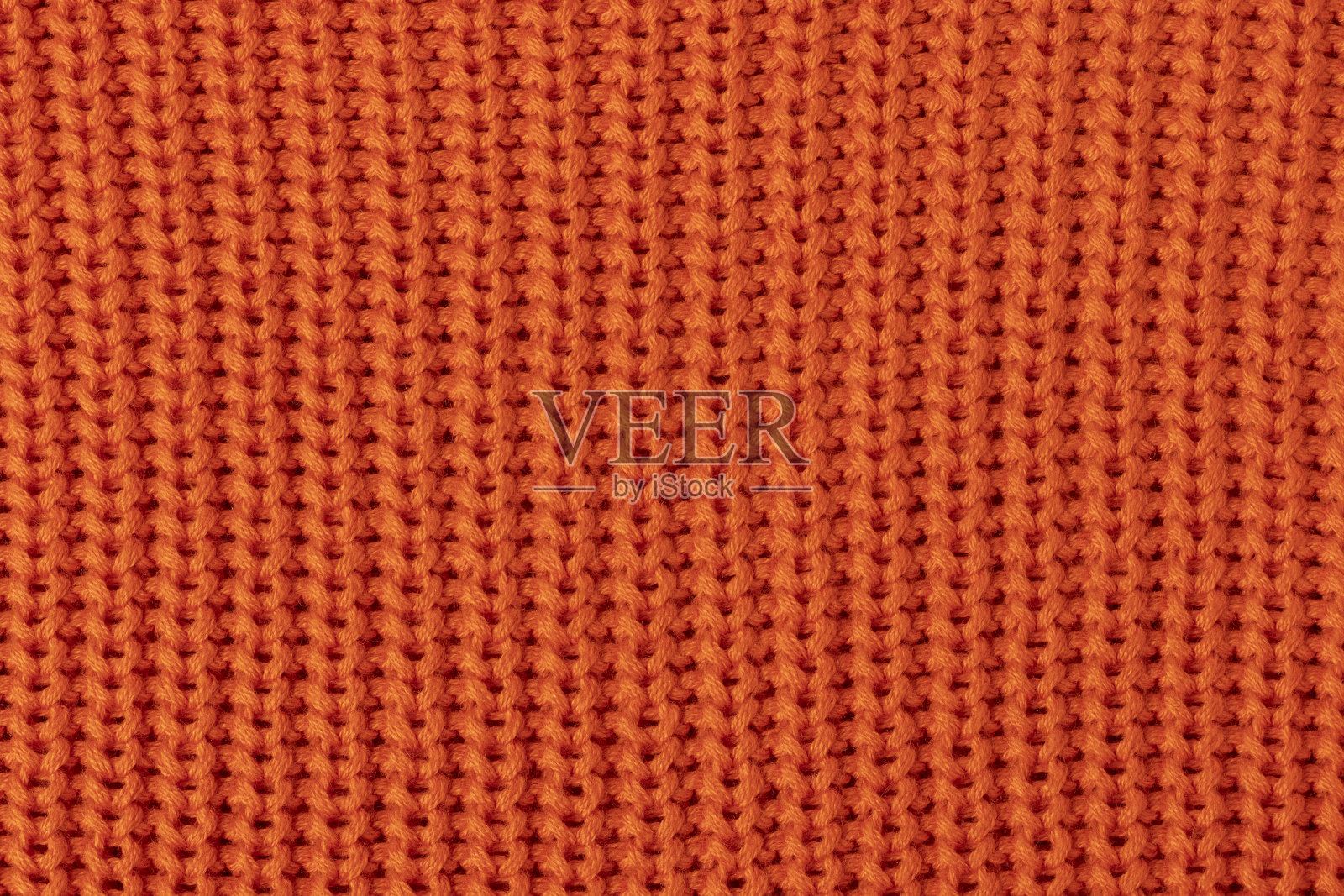 针织橘色织物。照片摄影图片