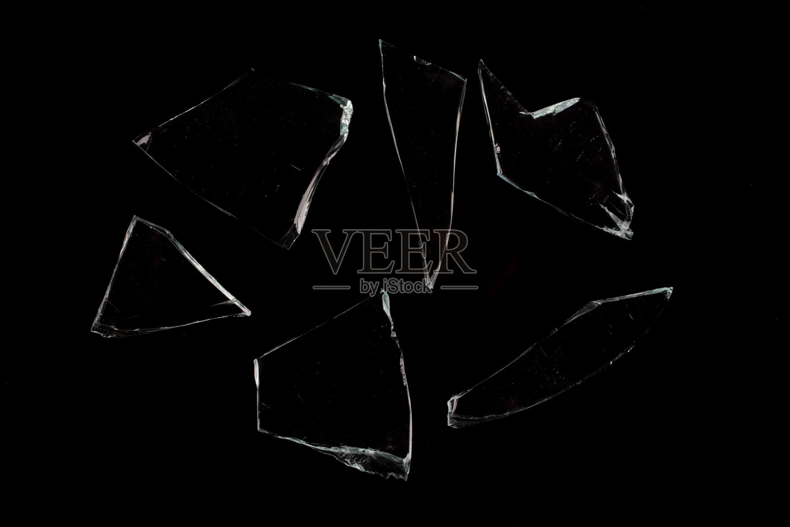 黑色背景上的几片玻璃碎片。照片摄影图片