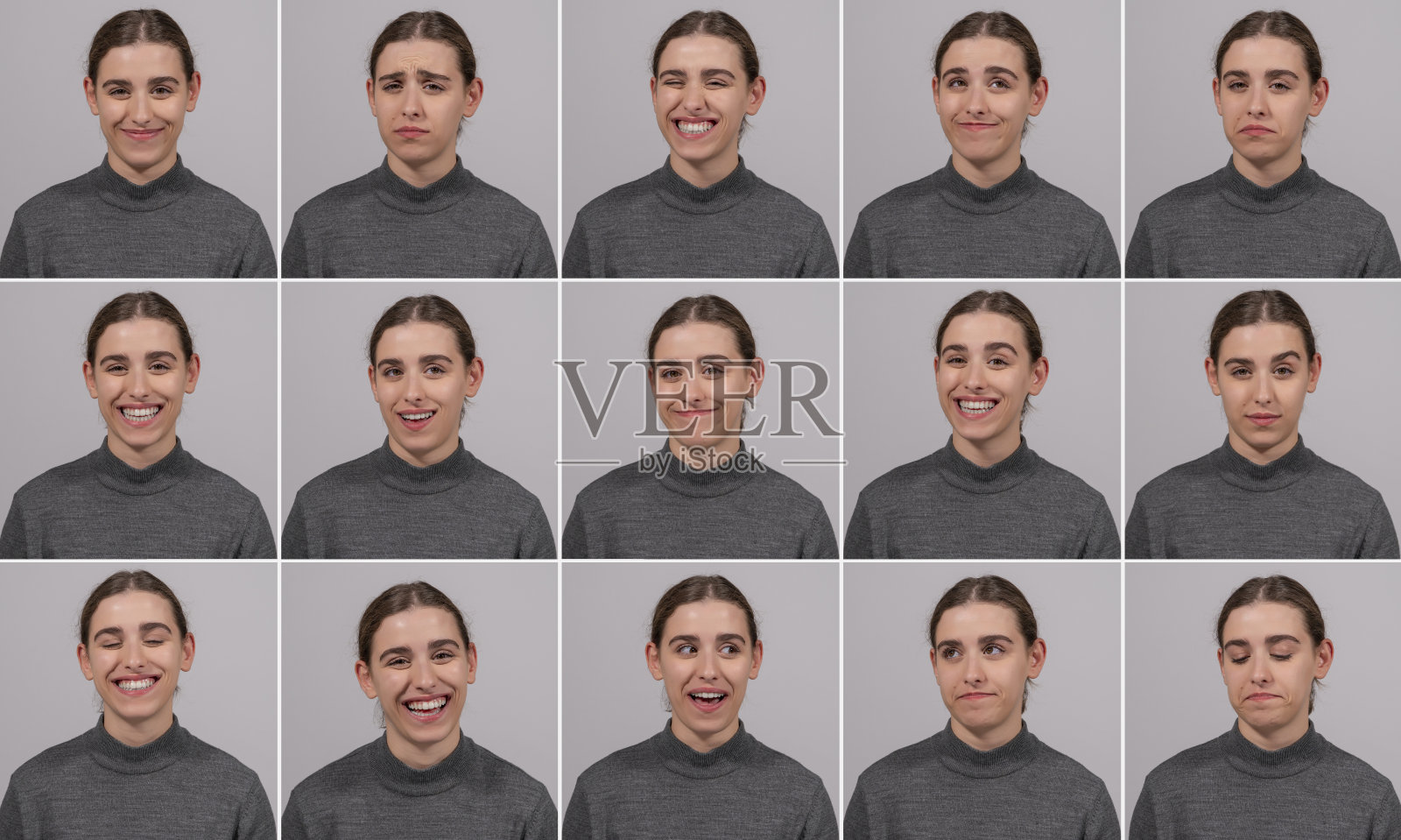 年轻美丽的模特女孩站在前面的灰色背景在不同的姿势。照片摄影图片