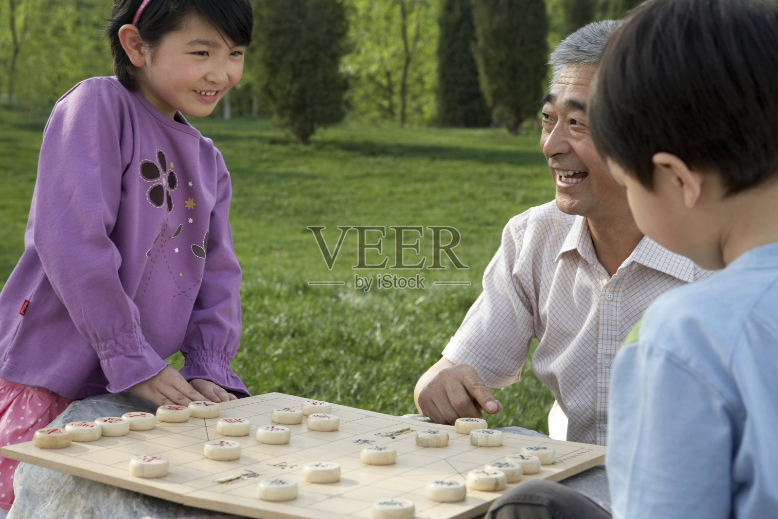 老人教小孩子下象棋照片摄影图片