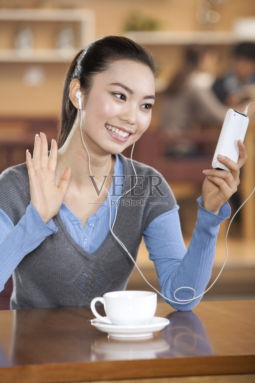 青年女子在书吧使用IPHONE照片摄影图片