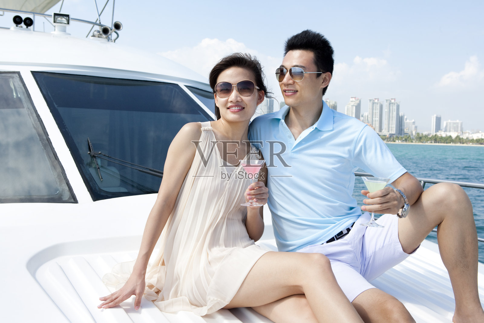 青年夫妇在游艇上喝鸡尾酒照片摄影图片