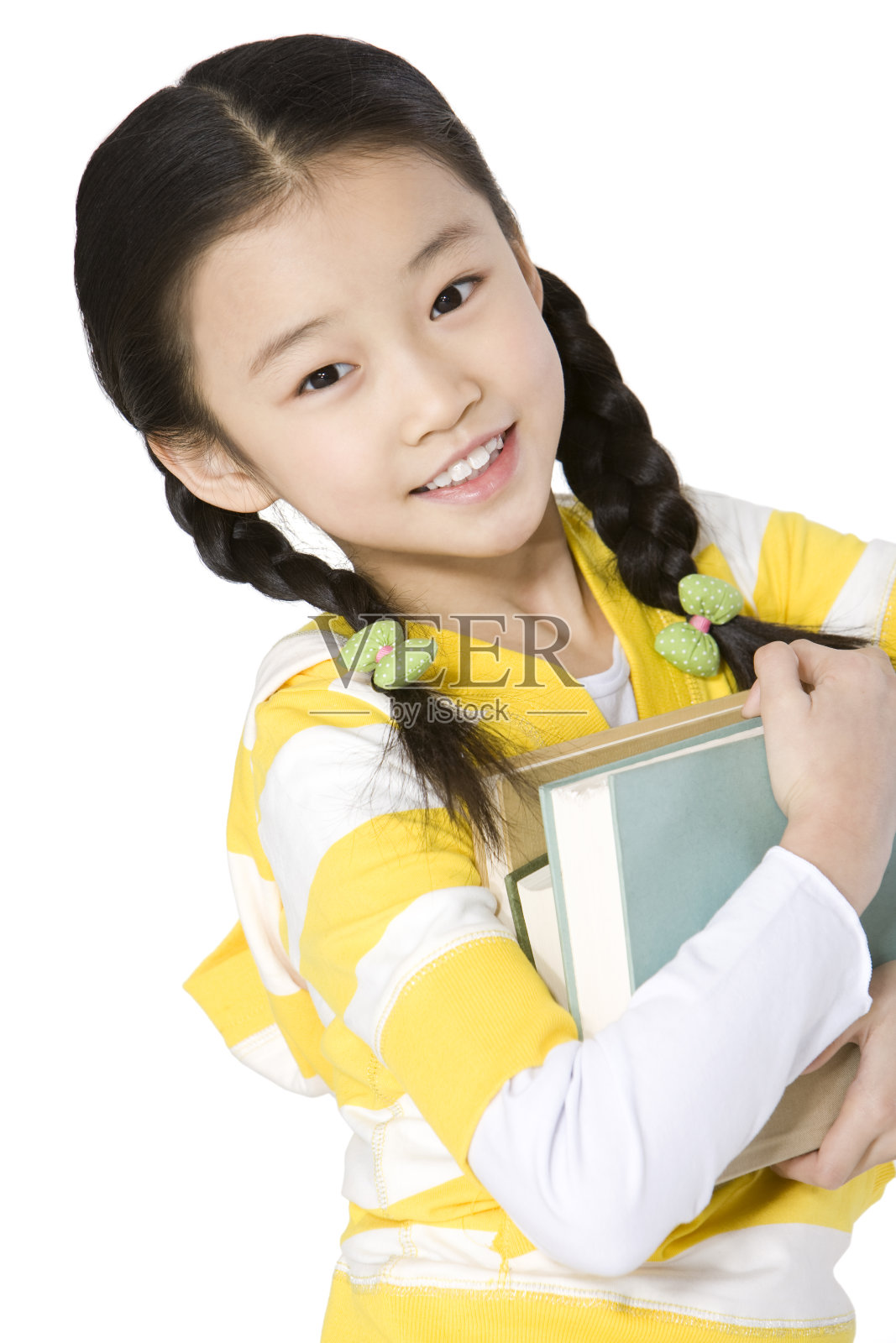 小女孩抱着图书照片摄影图片