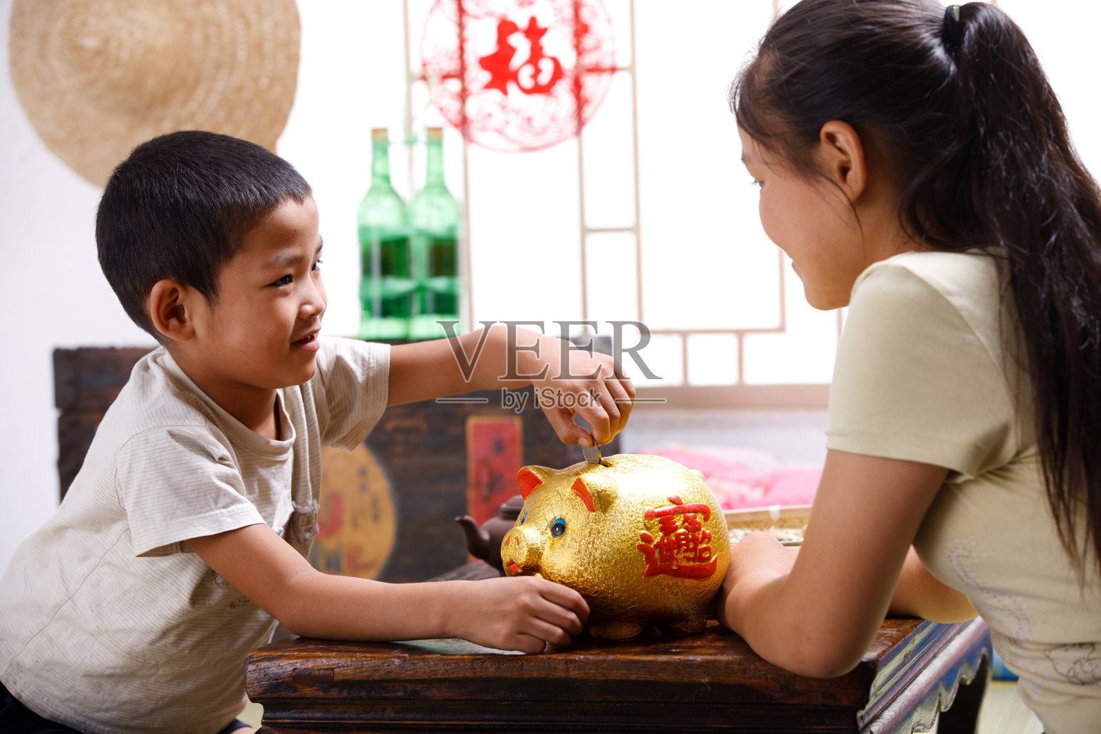 姐弟两人在家一起存钱照片摄影图片