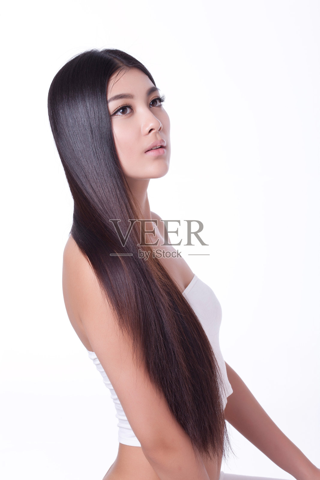 年轻女人亮丽丝缎般的头发照片摄影图片