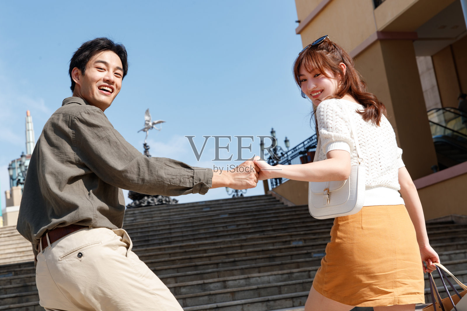 年轻情侣手牵手逛街照片摄影图片