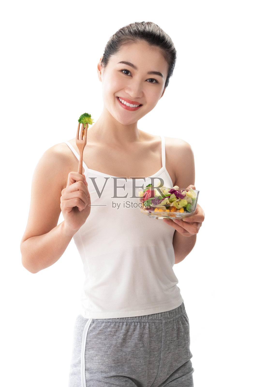 青年女人吃沙拉照片摄影图片