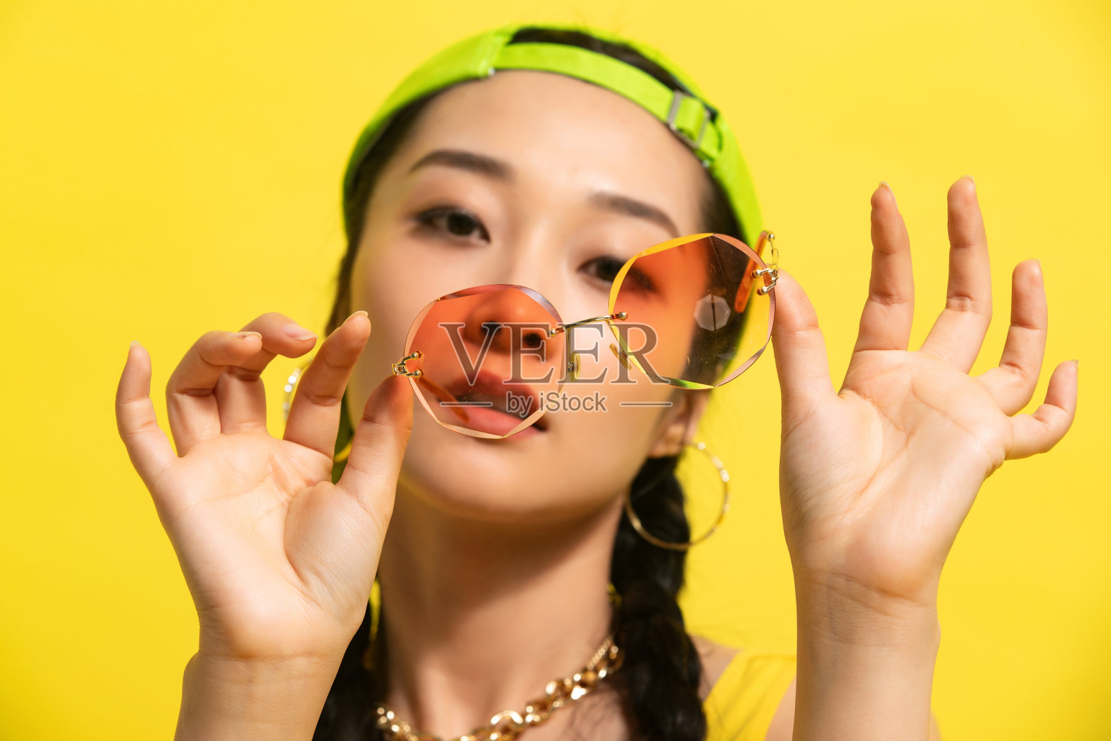 拿着墨镜的个性年轻女孩照片摄影图片