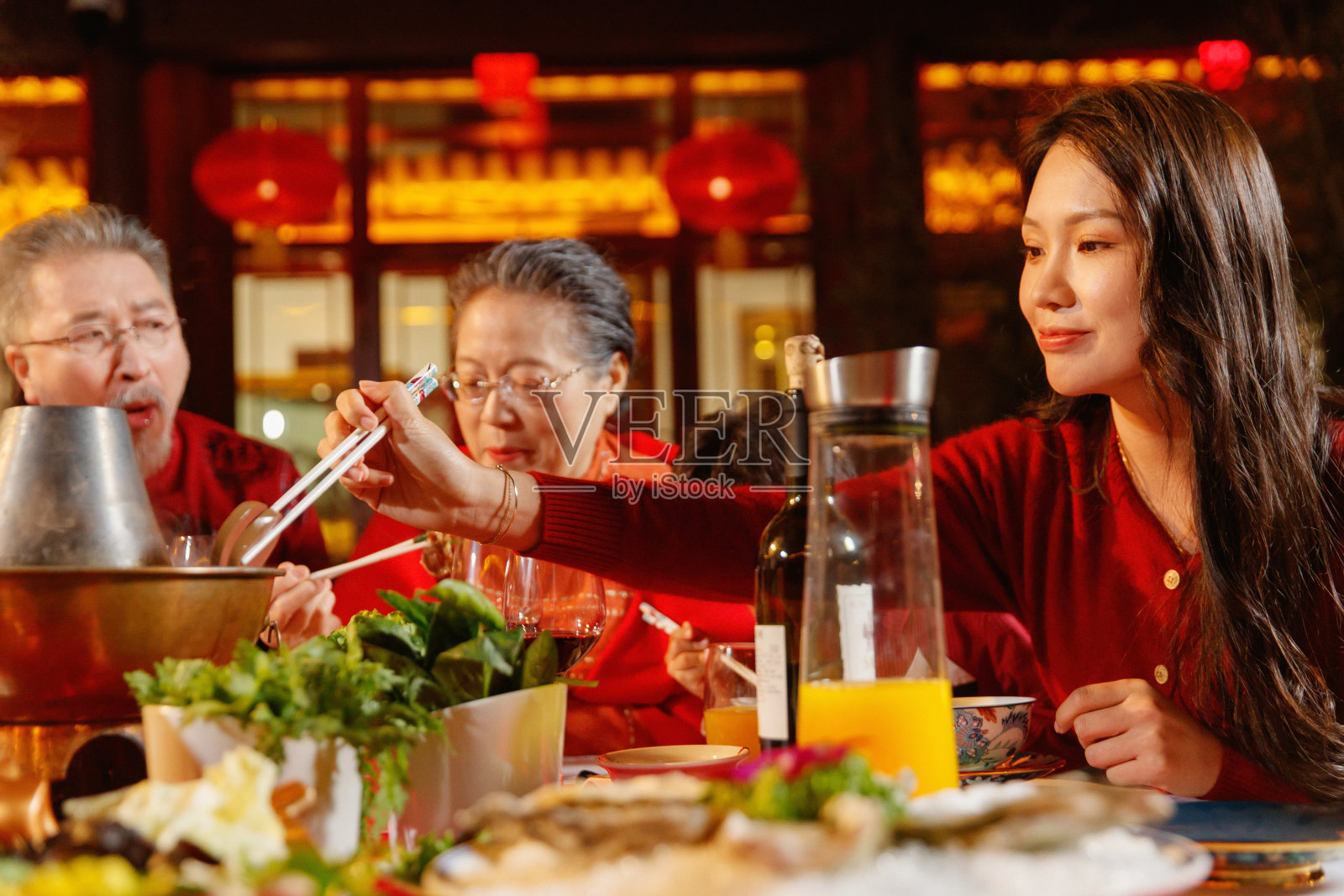 春节东方家庭在中式庭院内聚餐照片摄影图片
