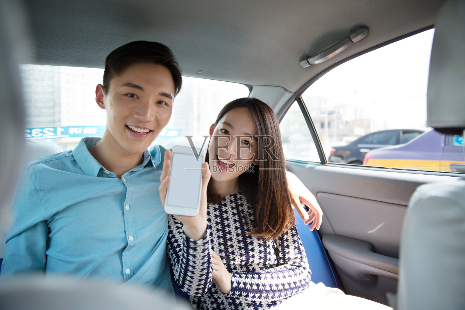 青年情侣在车内拿着手机导航照片摄影图片