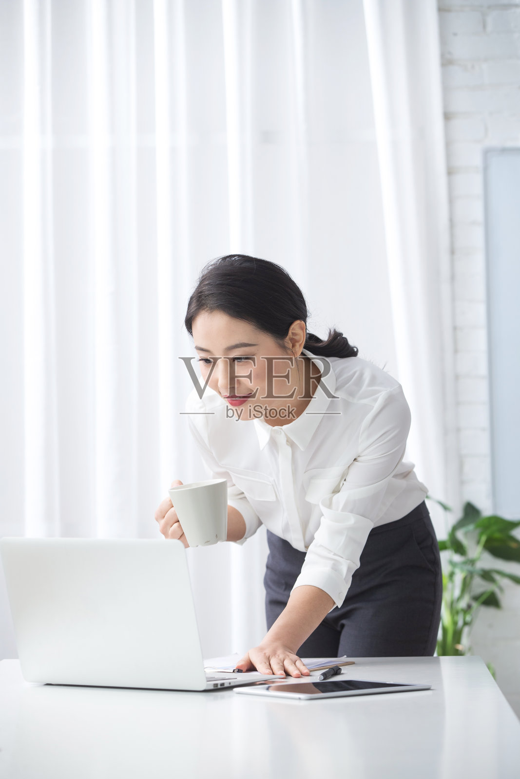 青年商务女人使用笔记本电脑办公照片摄影图片