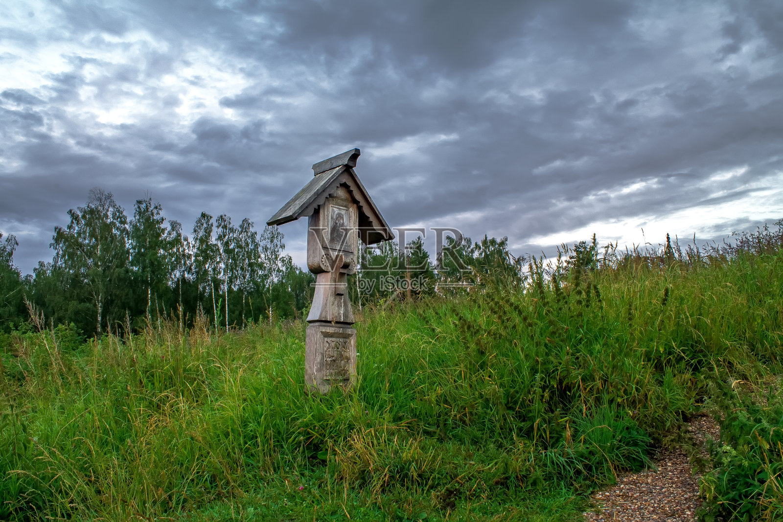 草地上的坟墓十字架，阴沉的天空照片摄影图片
