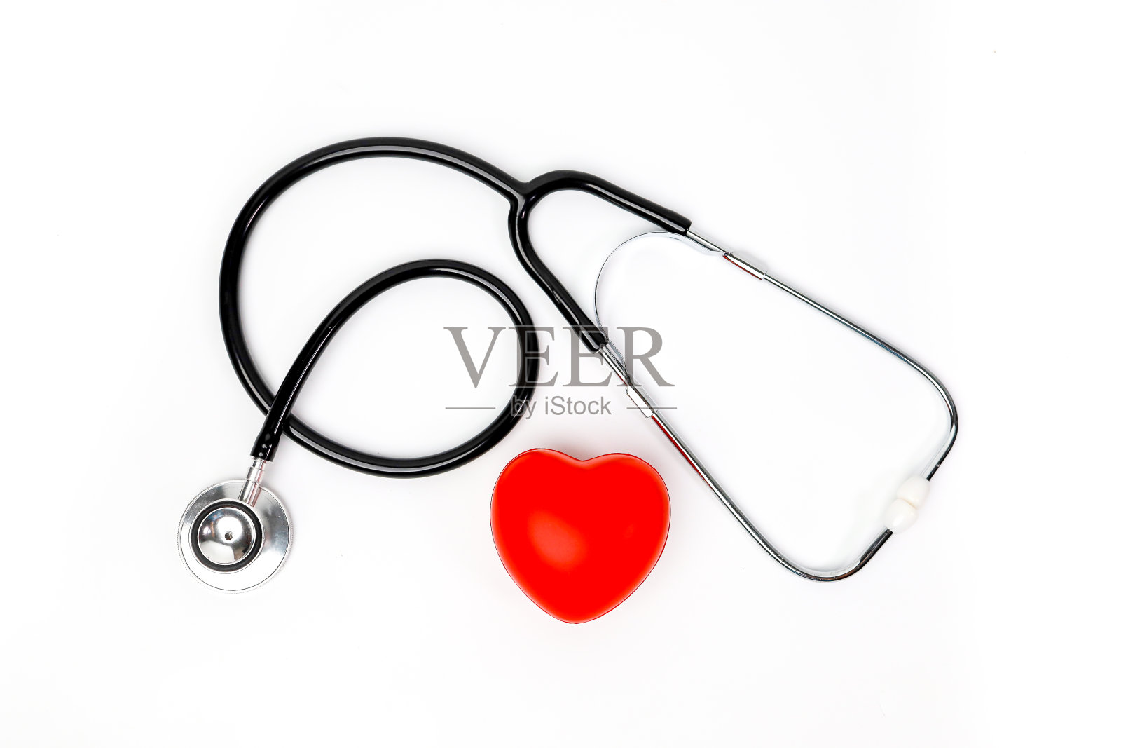 听诊器附近的橡胶心脏保健概念白色背景顶视图空间的文本照片摄影图片