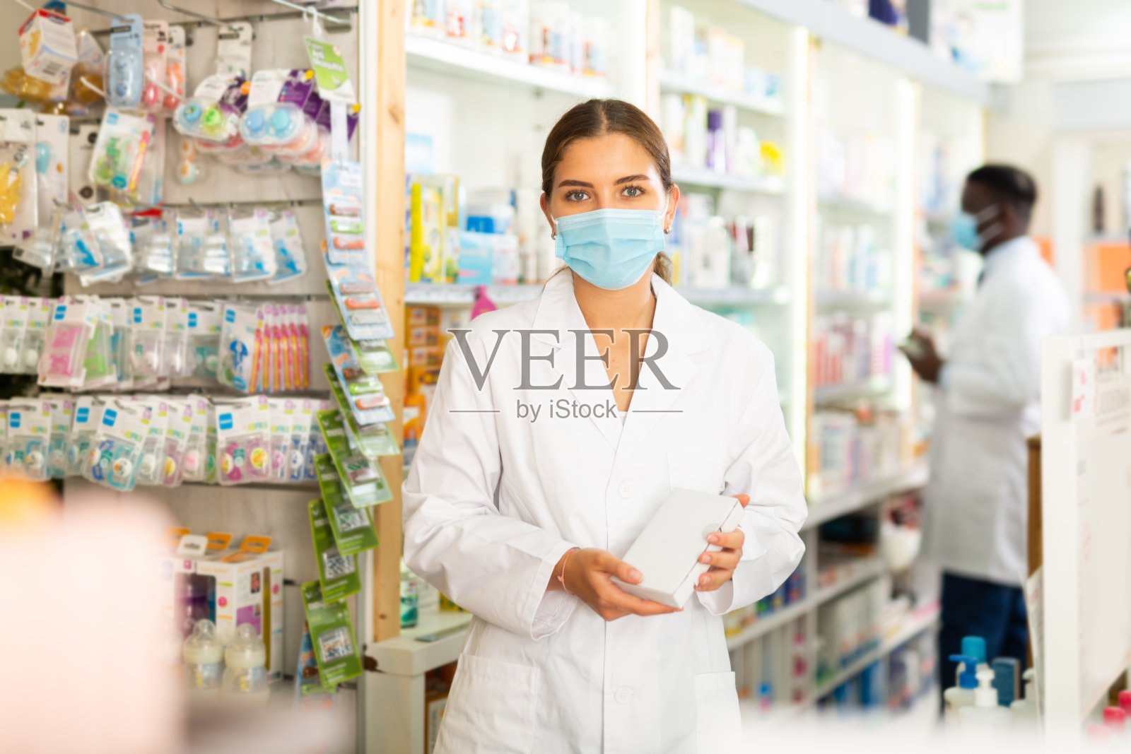 药师带着口罩和药品包装照片摄影图片