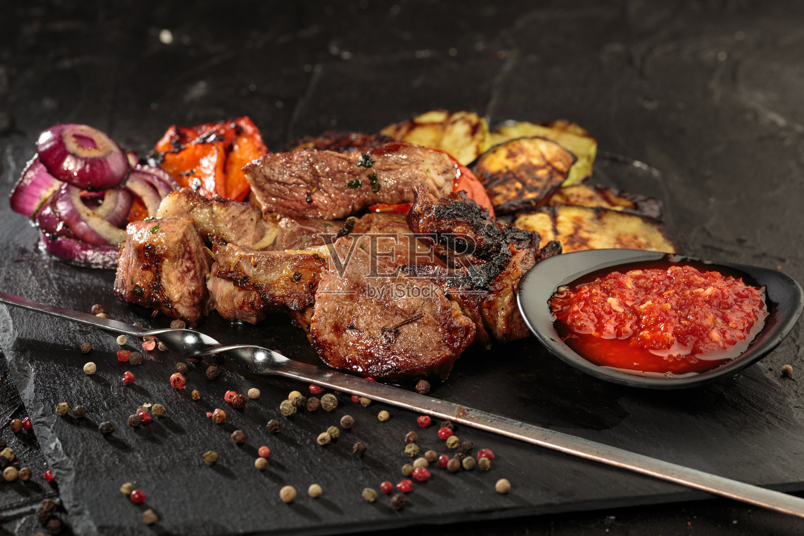 烤肉串或shish烤肉串，用烤过的蔬菜和辣酱在烤架上烤。关闭视图。照片摄影图片