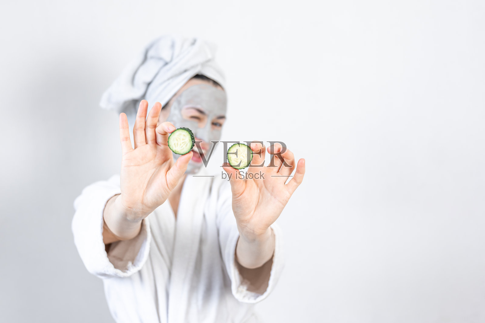 一个脸上戴着泥面具的年轻女人。照片摄影图片