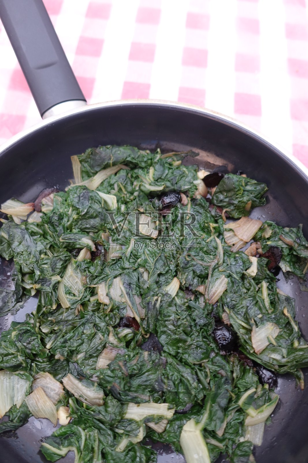 甜菜叶在水中煮熟，然后和黑橄榄一起变成棕色照片摄影图片