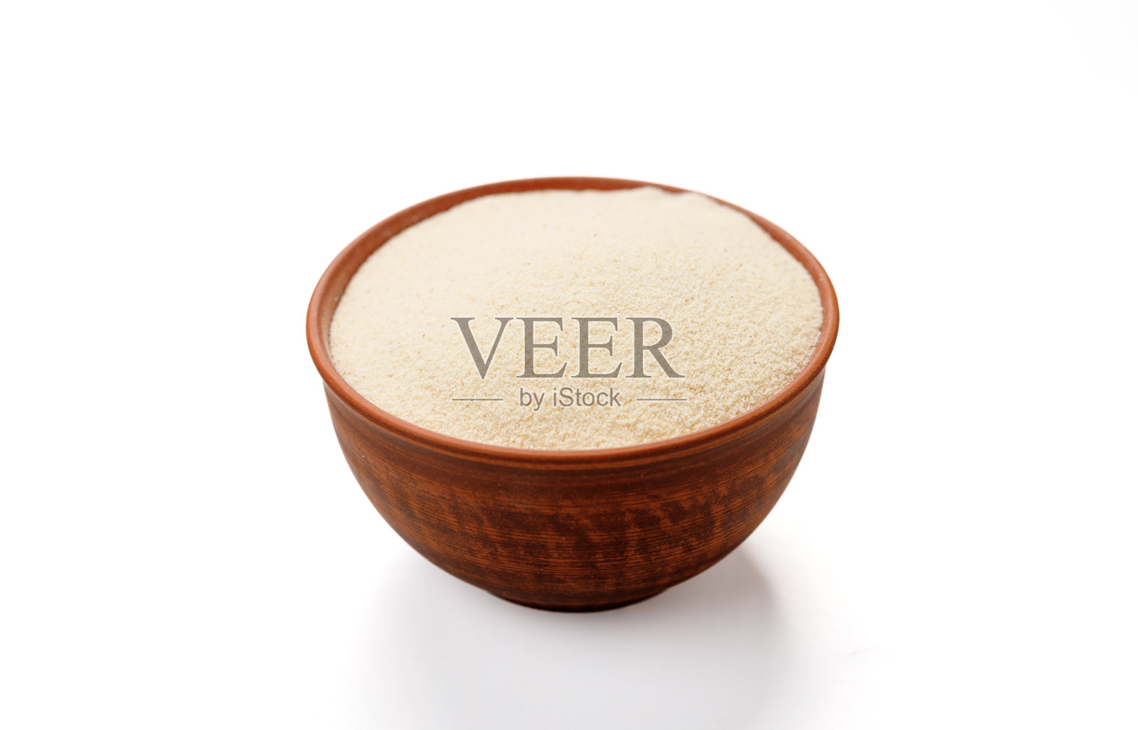 在白色的背景下，碗和袋子里的粗面粉被孤立起来。高质量的照片照片摄影图片