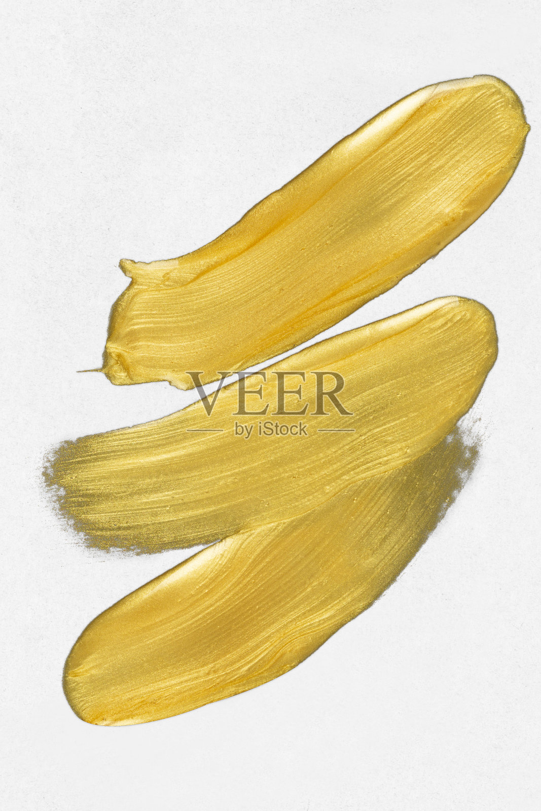 在白色背景上涂上金色颜料照片摄影图片