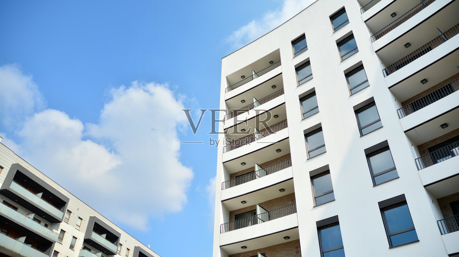 阳光明媚的日子里的现代欧式住宅建筑。新建多层住宅建筑外观。照片摄影图片