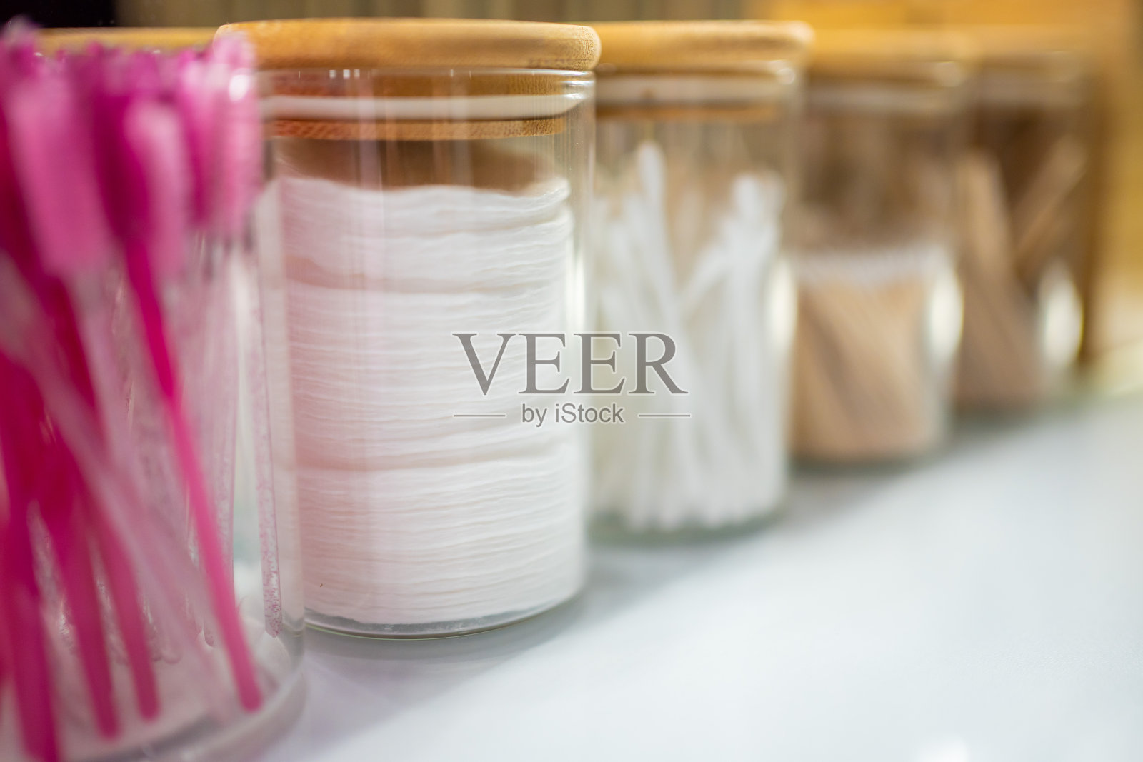 装有棉签、镊子和眉毛造型刷的容器，化妆和眉毛大师的配件照片摄影图片