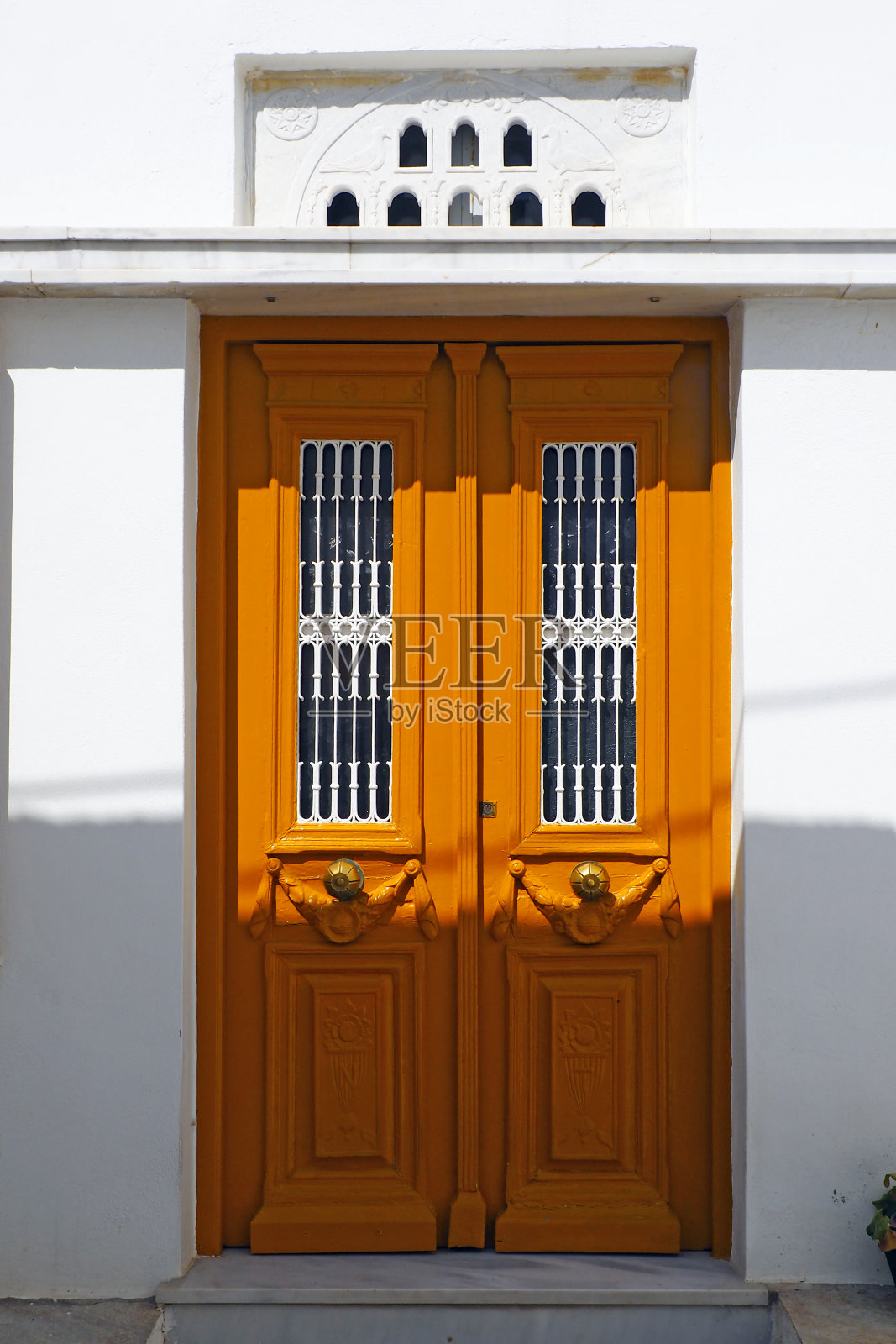在爱琴海中心的蒂诺斯岛上，古老而坚固的彩绘木门是基克拉迪斯群岛的魅力之一，这里是著名的白色村庄，居住着皮尔戈斯的大理石工匠照片摄影图片
