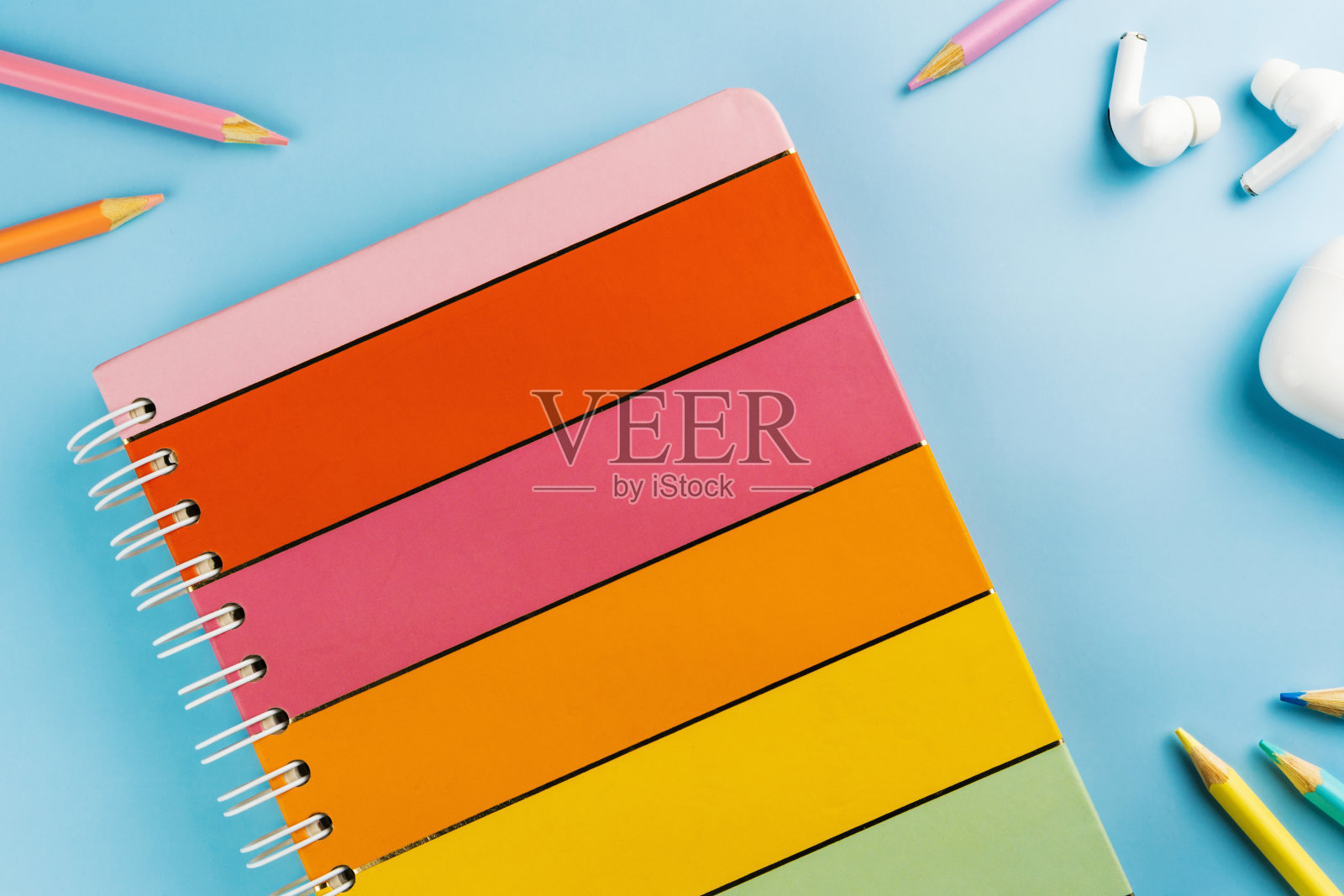 回到学校。学校用品的蓝色背景。蜡笔、剪刀、视频游戏手柄、耳机等儿童彩色配件。空间的文本。俯视图照片摄影图片