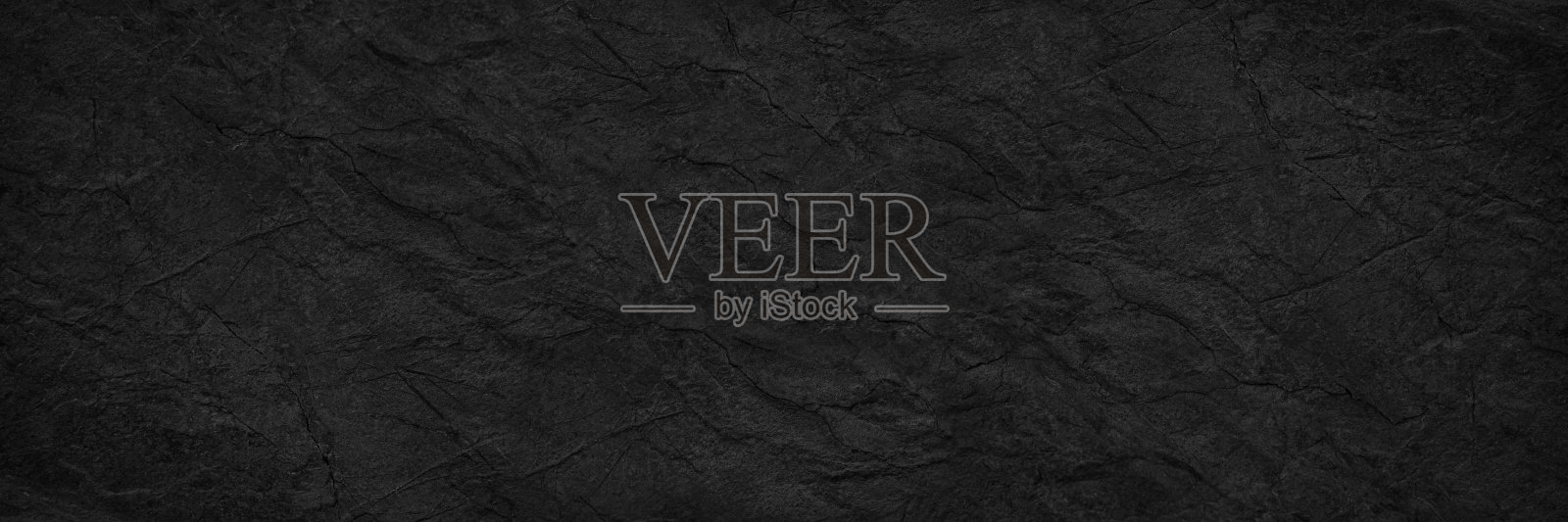 抽象的黑色背景。宽横幅。暗色岩石表面纹理。特写镜头。石头的背景照片摄影图片