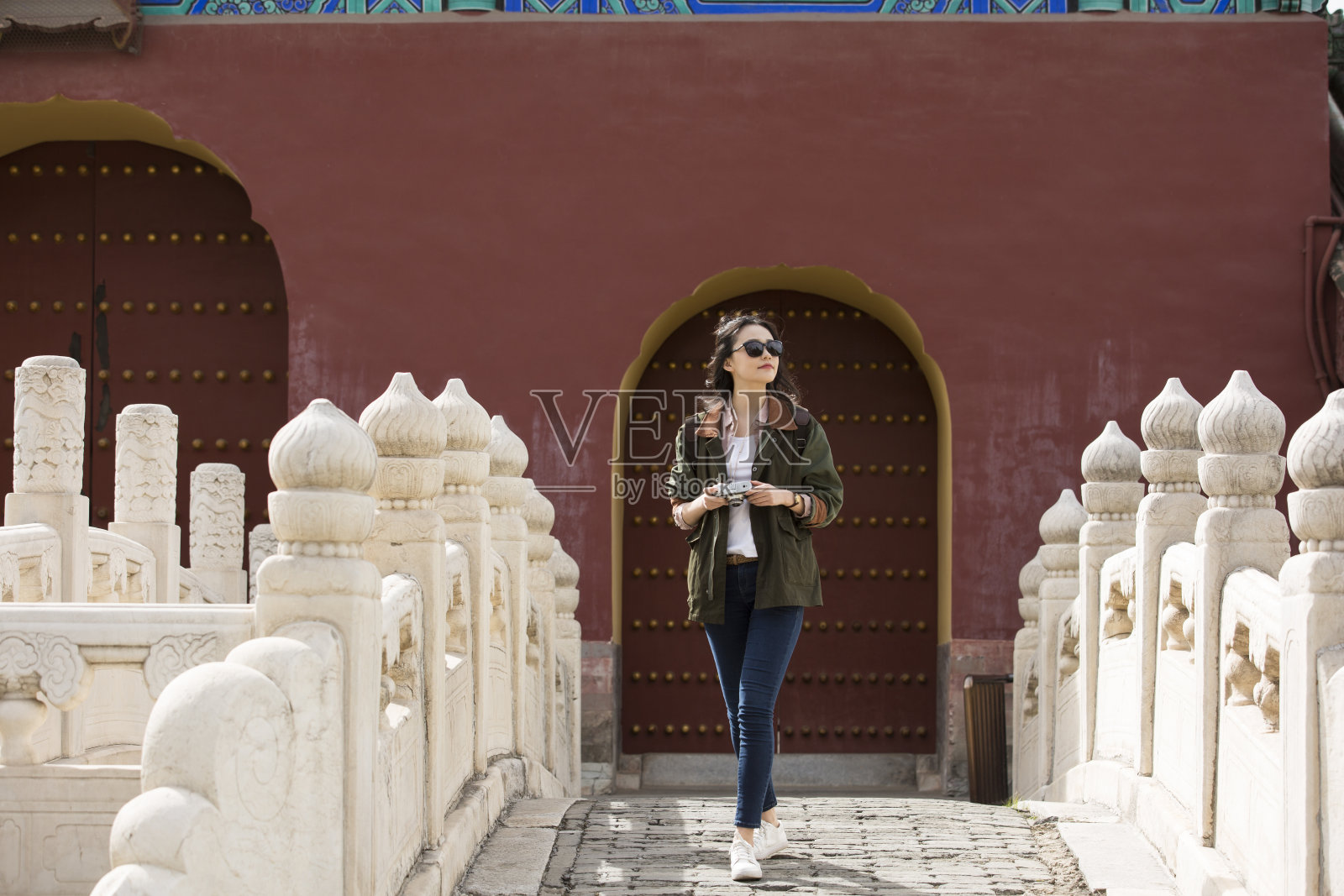 年轻的女摄影师走在古代拱桥的股票照片照片摄影图片