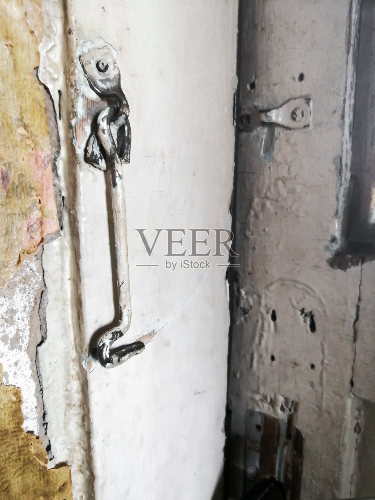 挂在门上。门上简单的锁。乡村风格-简单的锁在门上的钩子形式。照片摄影图片