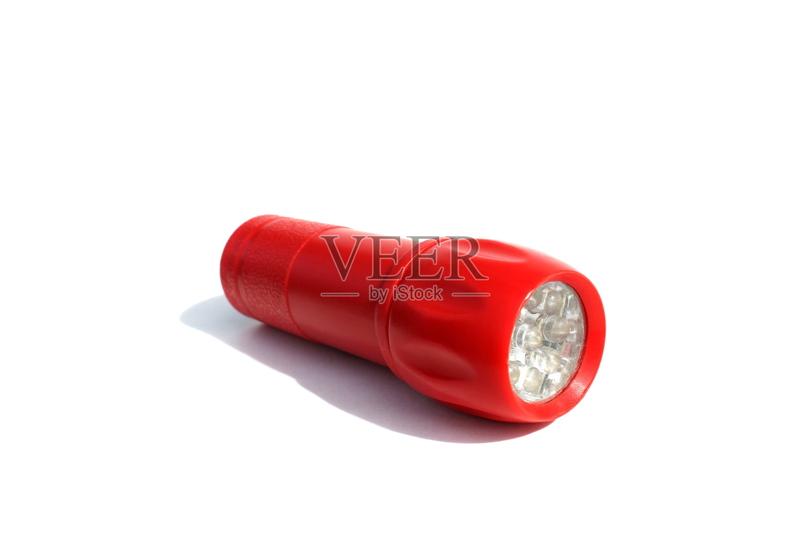 白色的背景上有一个红色的手电筒。照片摄影图片