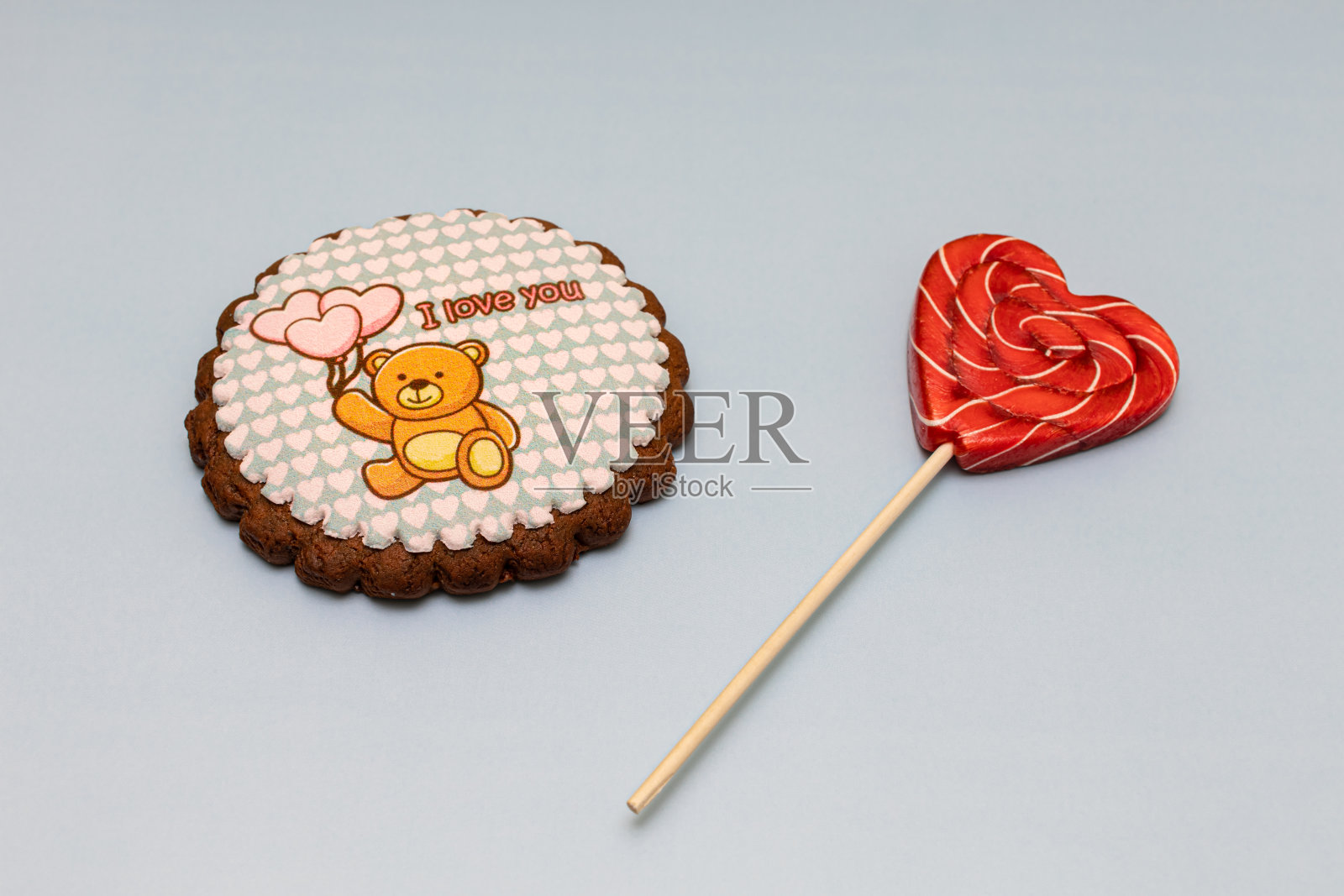 心形棒棒糖和小熊图案的饼干并排摆放照片摄影图片