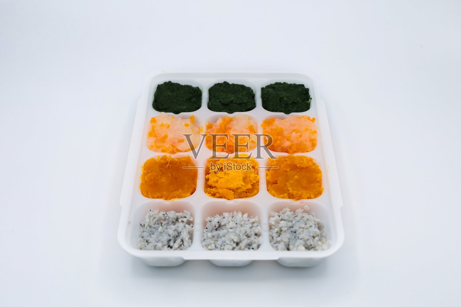 白腊和蔬菜糊婴儿食品放在一个分隔的容器里照片摄影图片