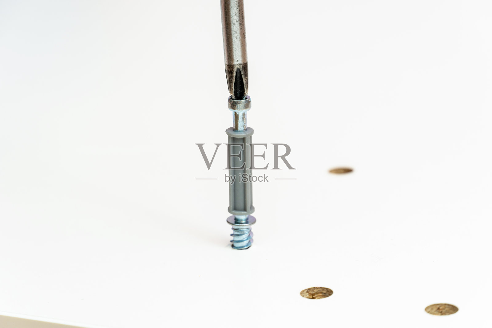 家具组装工艺，用螺丝刀将配件拧上照片摄影图片