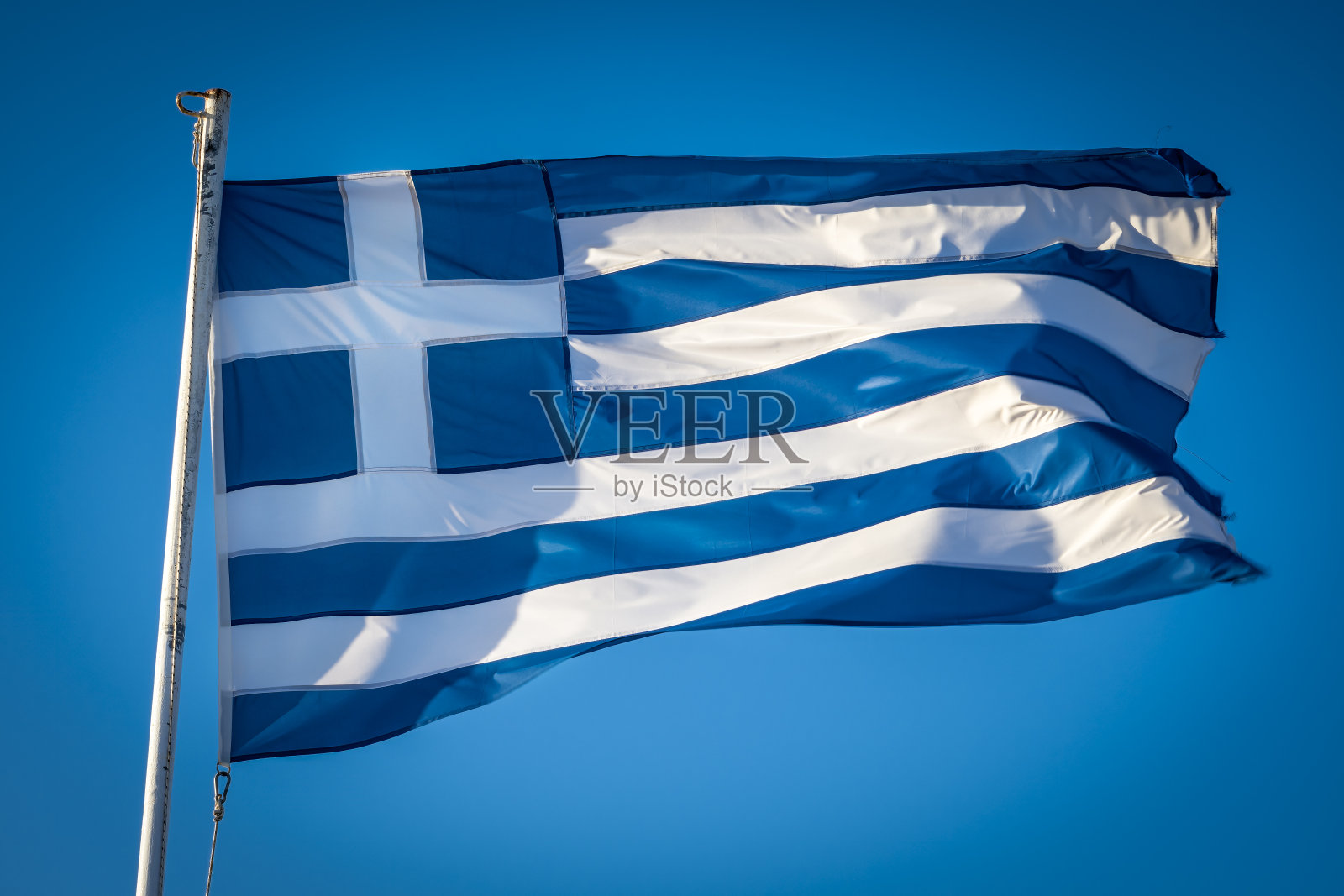 希腊国旗在蓝天下的阳光下飘扬照片摄影图片