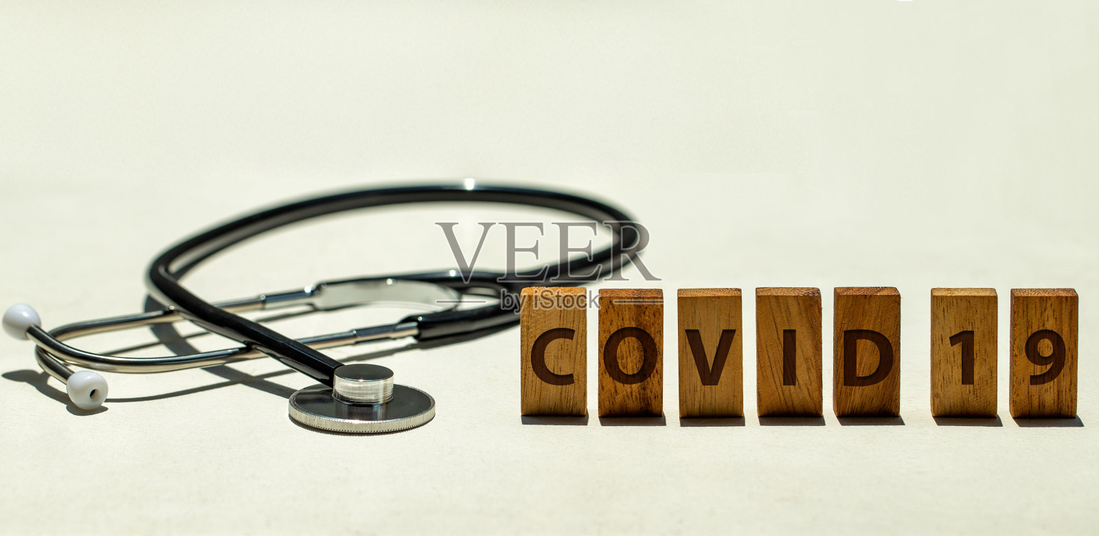 听诊器和写有“COVID 19”字样的木块照片摄影图片
