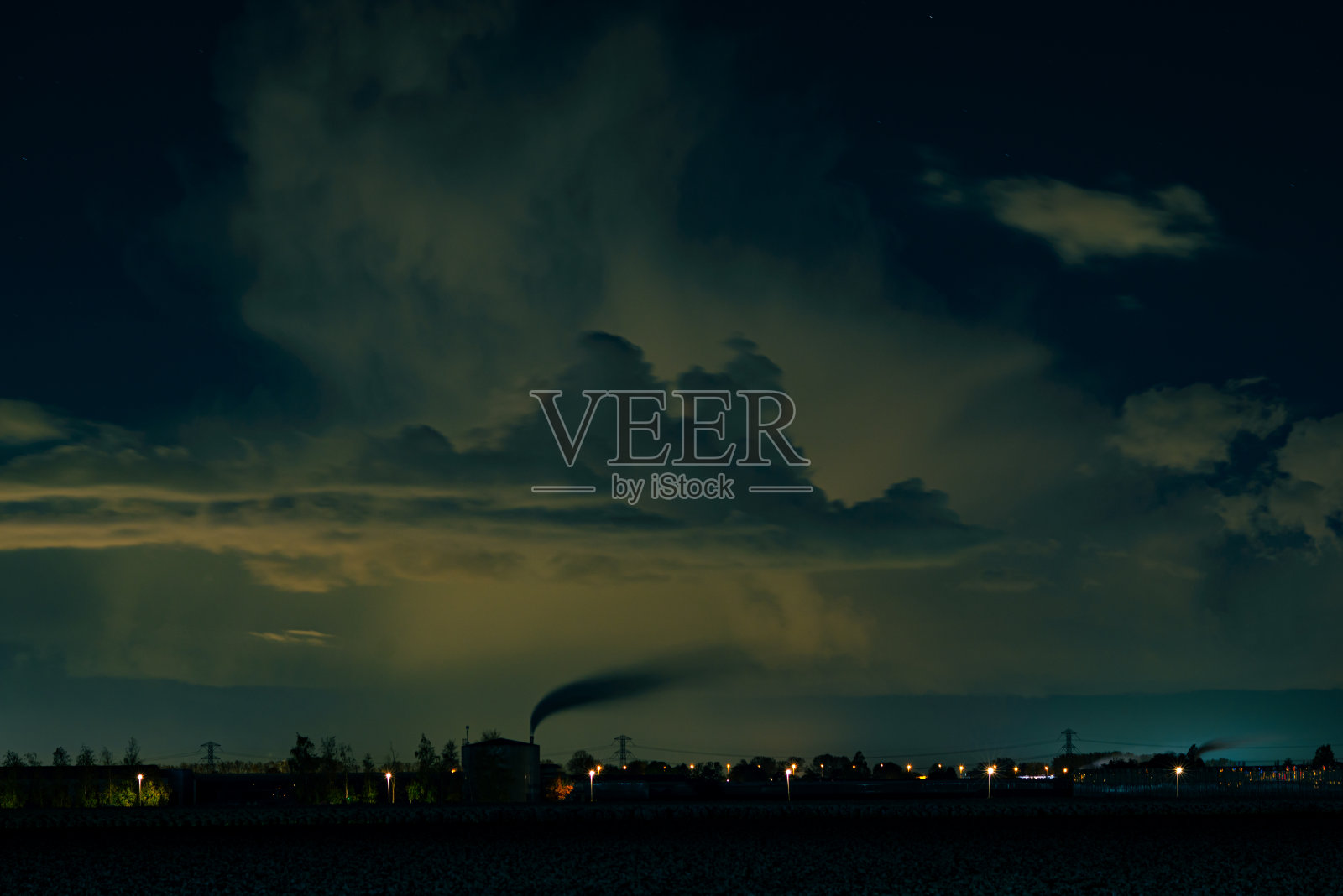 夜晚被温室和城市灯光照亮的云照片摄影图片