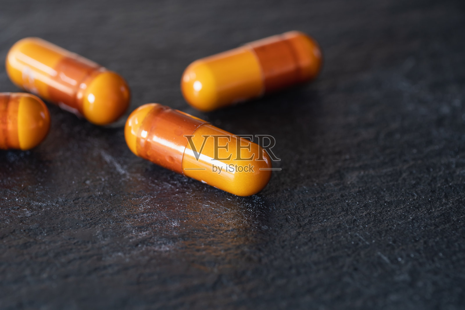 橙色胶囊药品。感冒药和止痛药。照片摄影图片