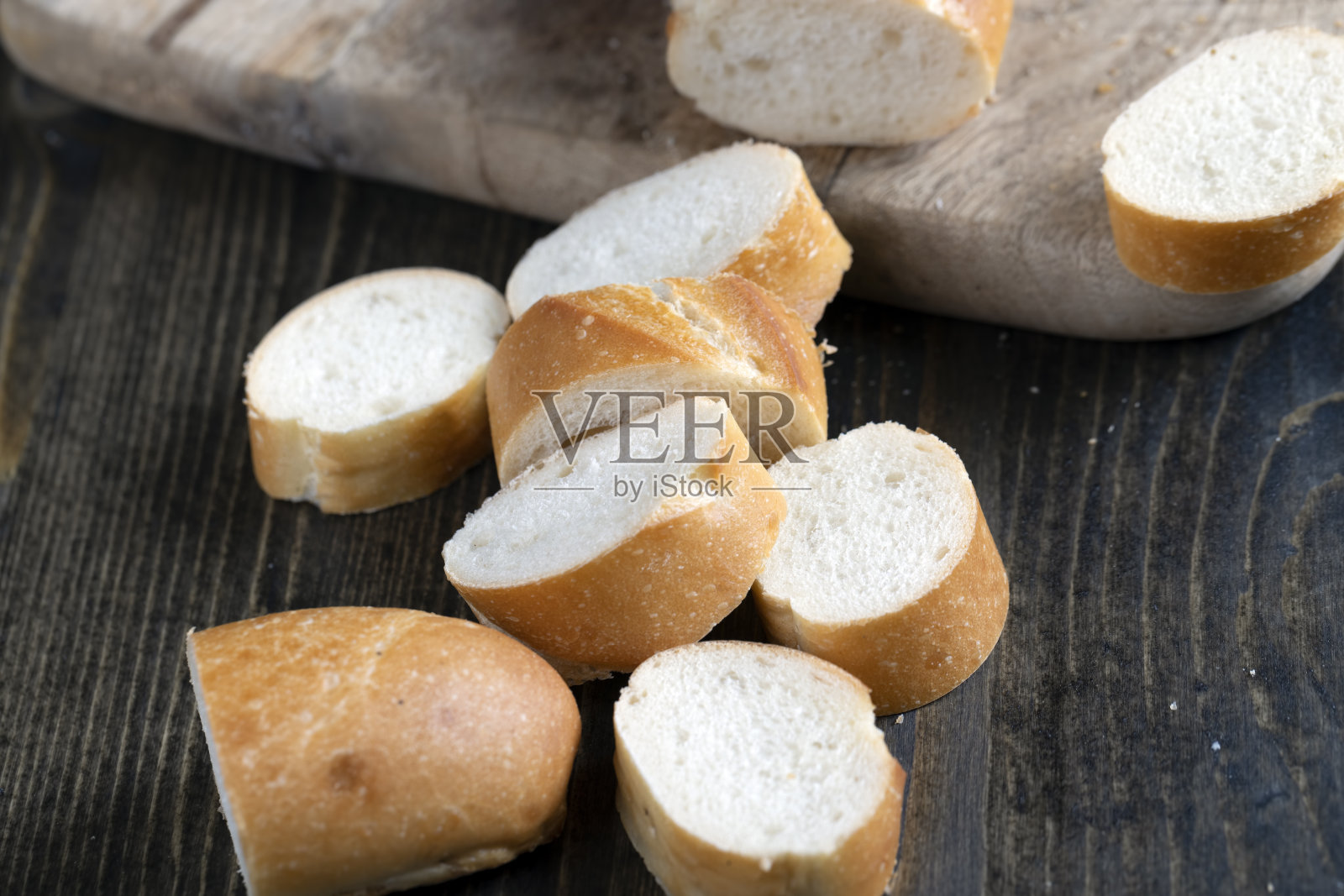 在砧板上切成片的小麦法棍照片摄影图片